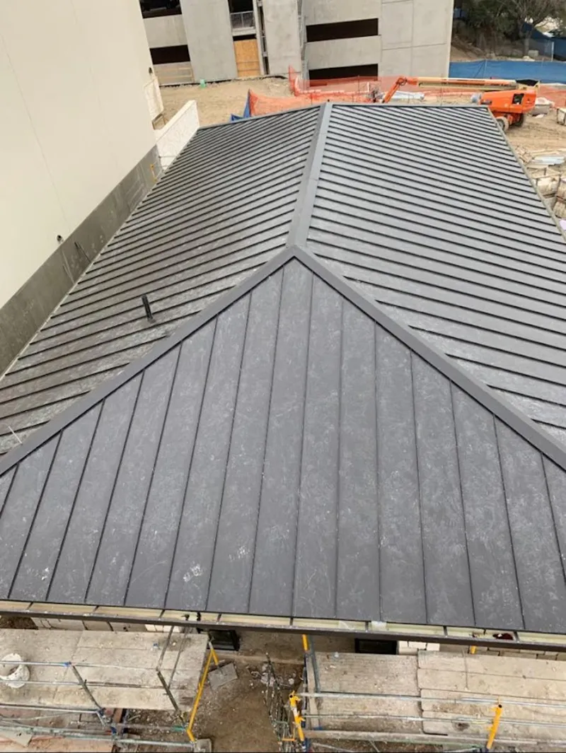 Commercial metal roof construction with crane equipment in West Donegal